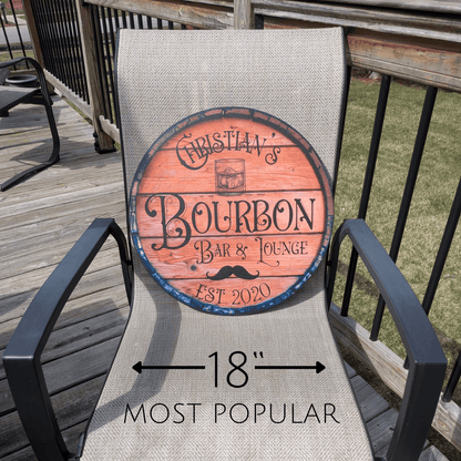 Whiskey Barrel Head Sign on outdoor chair with personalized 'Christian's Bourbon Bar & Lounge' design, 18 inches, most popular.