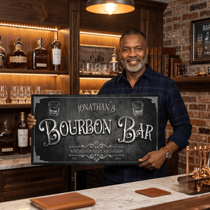 Smiling man holding a personalized Bourbon Bar Sign in a stylish home bar setting.
