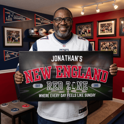Man holding personalized New England Football Sign in a football-themed room, celebrating New England fandom.