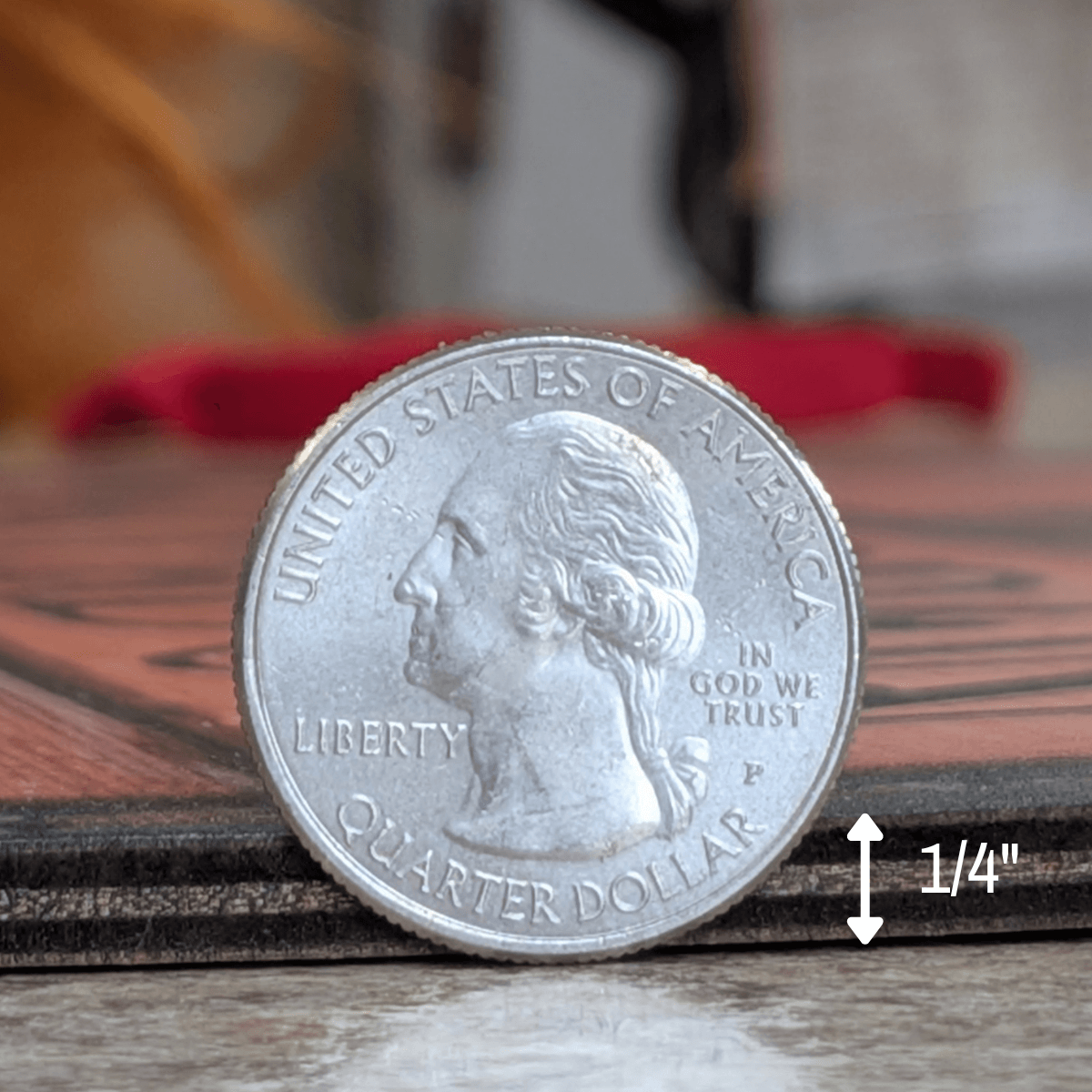 Close-up of a quarter dollar coin showing United States of America and measurement of 1/4 inch depth for the whiskey barrel head sign