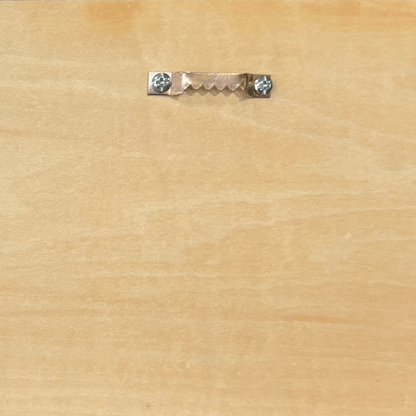 D-ring hanger on a wood surface used for mounting a whiskey barrel head sign securely.