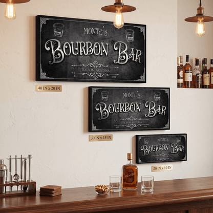 Three sizes of personalized Bourbon Bar Sign displayed on a wall above a home bar, featuring a vintage design.
