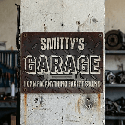 Metal Garage Sign with custom text 'Smitty's Garage' and a humorous tagline about fixing anything except stupid.